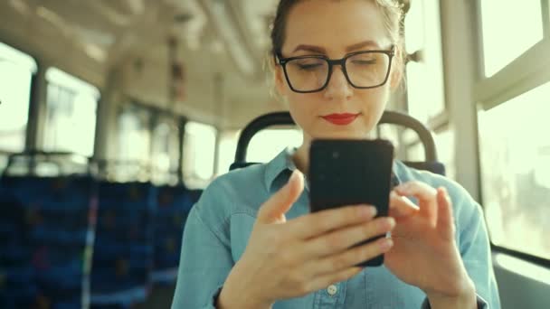 Public Transport Slow Motion Woman Glasses Tram Using Smartphone Chatting — ストック動画