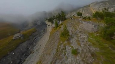 İsviçre Alpleri 'nde bulutlu bir sonbahar gününde FPV dağlık bir alanda manevra yapabilir. Kandersteg, İsviçre.
