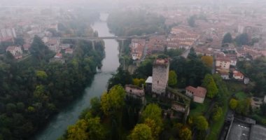 Milan ve Bergamo arasındaki kırsal alanın havadan görüntüsü. Adda Nehri, köprü, küçük kasabadaki eski binalar, kırmızı çatılar, sisli bir günde ağaçlar. Lombardy, İtalya.