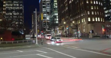 Time lapse crossroads with cars and people crossing street at night, bus moving fast in big city in evening. Time-lapse cars rush hour driveway, pedestrians crossing intersection