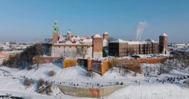 Aerial view of Wawel Royal Castle covered with snow and Vistula river in winter. Sunny frosty day. Krakow, Poland