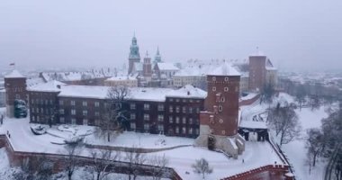 Aerial view of Wawel Royal Castle and Cathedral covered with snow in winter. Gloomy frosty day. Krakow, Poland