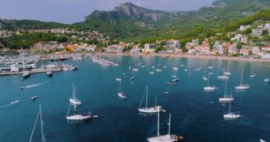 Majorca, Spain. Aerial view of summer resort town Port de Soller on Mallorca Majorca island, sandy beach, boats, yachts, clear waters of Mediterranean Sea - landscape of Balearic Islands from above