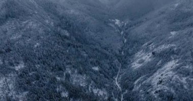 Flight over a fabulous snow-covered mountain landscape. Fairy winter landscape on a frosty gloomy day. Tatra Mountains, Zakopane, Poland