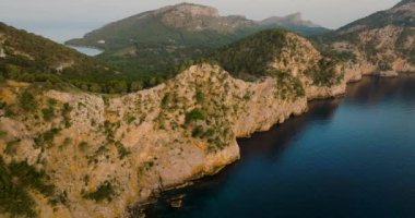 Scenic aerial view of a mountainous region in Majorca with cliffs. Panoramic view of Mirador Es Colomer in Sierra de Tramuntana and blue sea, Balearic Islands, Spain.