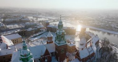 Aerial view of Wawel Royal Castle covered with snow and Vistula river in winter. Sunny frosty day. Krakow, Poland