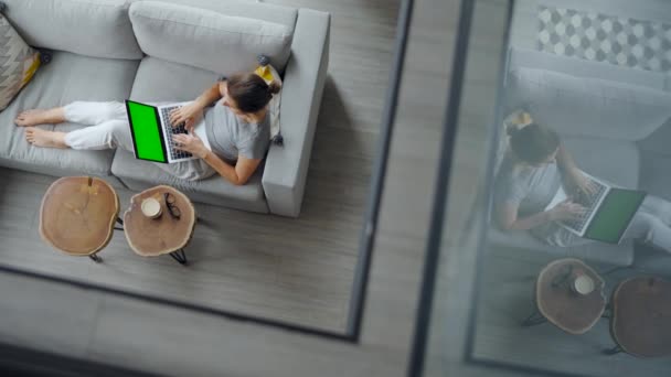 Overhead Shot Woman Using Laptop Green Mock Screen Lying Couch — Stockvideo