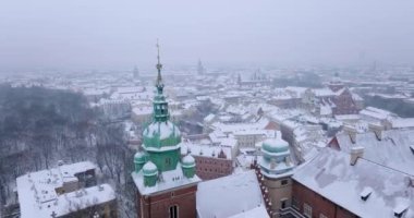 Aerial view of Wawel Royal Castle and Cathedral covered with snow in winter. Gloomy frosty day. Krakow, Poland