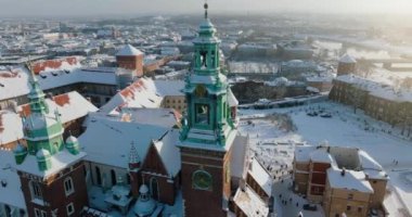 Aerial view of Wawel Royal Castle covered with snow and Vistula river in winter. Sunny frosty day. Krakow, Poland