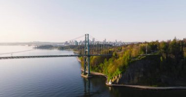 Şafakta Lions Gate Köprüsü ve Stanley Parkı 'nın havadan görüntüsü. Arka planda Vancouver şehir merkezi var. Britanya Kolombiyası Kanada 