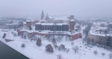 Aerial view of Wawel Royal Castle and Cathedral covered with snow in winter. Gloomy frosty day. Krakow, Poland