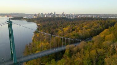 Şafakta Lions Gate Köprüsü ve Stanley Parkı 'nın havadan görüntüsü. Arka planda Vancouver şehir merkezi var. Britanya Kolombiyası Kanada 