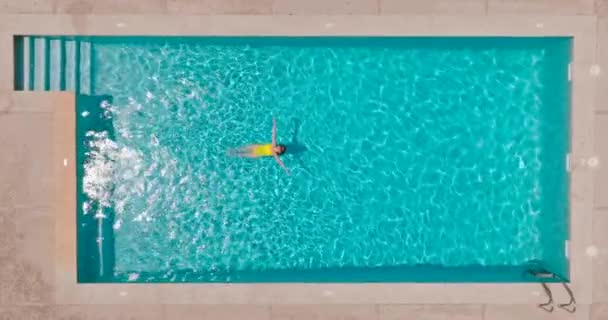 Top View Woman Yellow Swimsuit Lying Her Back Pool Slow — Stock Video