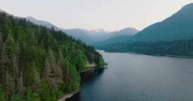 Kuzey Vancouver, British Columbia, Kanada 'daki Capilano Gölü ve dağ manzarası üzerinde insansız hava aracı görüntüsü.