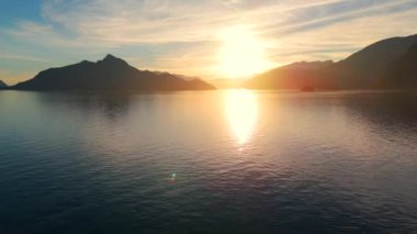 Vancouver 'ın kuzeyindeki güzel günbatımında deniz manzarası. Dağların siluetlerinin üzerine güneş batıyor. British Columbia, Kanada.