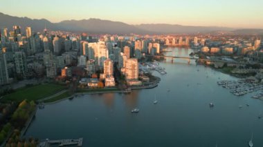 Aerial view of the skyscrapers in Downtown, mountains, False Creek. Vancouver, British Columbia, Canada at sunset. 