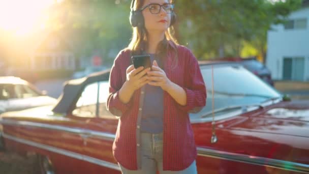 Woman Headphones Standing Outdoors Red Vintage Car Using Smartphone Green — Stock Video