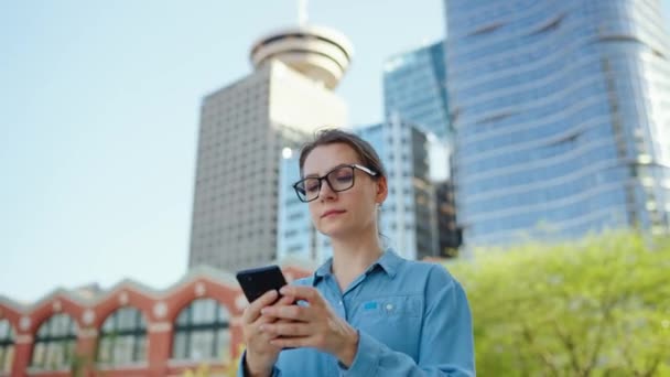 Caucasian Woman Glasses Walking City Using Smartphone Skyscrapers Background Communication — Stock Video
