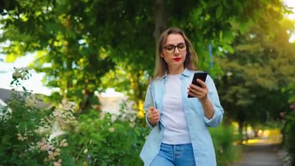 Ευτυχισμένη Γυναίκα Φορητό Υπολογιστή Και Smartphone Στα Χέρια Της Περπατώντας — Αρχείο Βίντεο