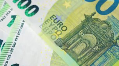 Karmaşık tasarımı ve çeşitli güvenlik özelliklerini vurgulayan 100 avroluk banknotların yakın plan ve ayrıntılı görünümü. 