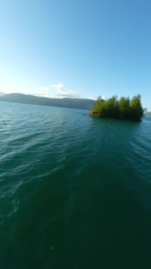 Kanada 'da göz kamaştırıcı sonbahar manzarası. Dağ yamaçlarındaki renkli ormanın havadan görünüşü ve Harrison Gölü, British Columbia. FPV insansız hava aracı tarafından çekildi.
