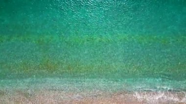 Yukarıdan aşağıya çakıl taşı plajı ve kristal berrak su görüntüsü. Rodos, Yunanistan