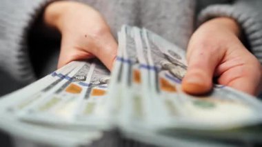 Amerikan Doları 'nı sayan bir kadın, yakın plan. Yatırım, başarı, finansal beklentiler veya kariyer gelişimi kavramı. Yavaş çekim