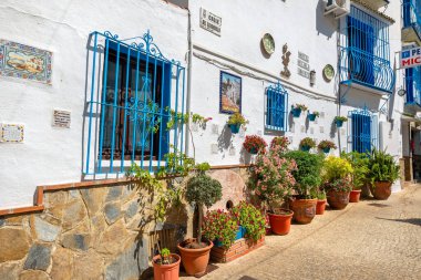 TORREMOLINOS, ANDALUSIA, SPAIN - JULY 9, 2019: View to typical pedestrian street with picturesque facades