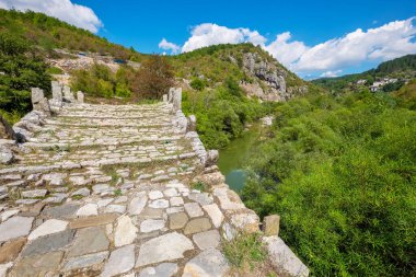 View to stone bridge of Kalogeriko (or Plakida) over Voidomatis river. Central Zagoria, Epirus, Greece