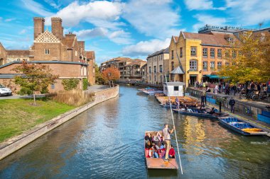 CAMBRIDGE, ENGLAND - OCTOBER 15, 2022: Punting on the River Cam between of Magdalene College and Scudamore's Quayside
