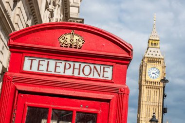Typical red phone box with Big Ben in the backdrop. London, England. Selective focus