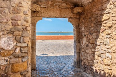 Porta Nova arch, one of historical gate in old town at Faro. Algarve, Portugal clipart