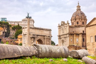 Remains of columns near Arch Septimius Severus and Church Santi Luca e Martina in Roman Forum. Rome, Italy clipart