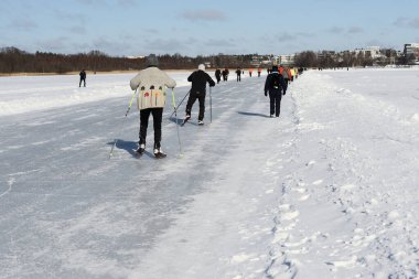 ice skating on Tuusul lake in Jarvenpaa on a sunny winter day February 26, 2023