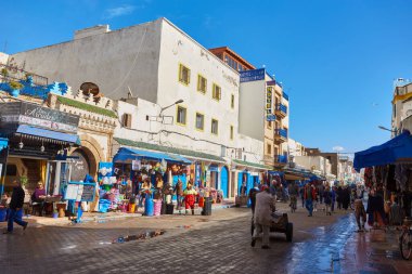 ESSAOUIRA, MOROCCO. 13 th February, 2017: Ancient walls of the medina, merchants hurrying on business, after the rain