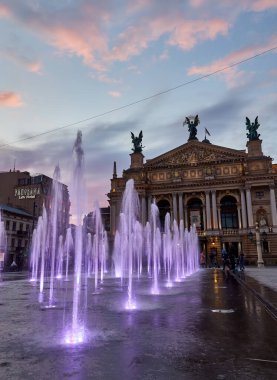 Lviv, Ukraine - April 30 2021: The Solomiya Krushelnytska Lviv State Academic Theater of Opera and Ballet or Lviv Opera and coloful dancing fountains in Lviv Ukraine