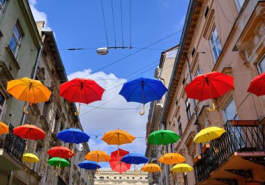 Romantically decorated with the umbrellas hanging from the wires on the narrow street of the old city