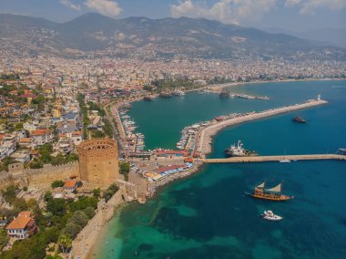 Kizil Kule or Red Tower and port aerial panoramic view in Alanya city, Antalya Province on the southern coast of Turkey. Summer photo taken from a drone