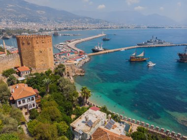 Kizil Kule or Red Tower and port aerial panoramic view in Alanya city, Antalya Province on the southern coast of Turkey. Summer photo taken from a drone