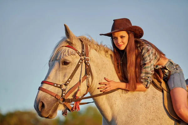 カウボーイ帽子の長い髪の美しい若い女性は 自然の中で茶色の馬と — ストック写真
