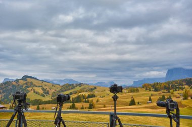 Several cameras are on tripods. Shooting a mountain landscape in the Dolomites, Italy, Europe