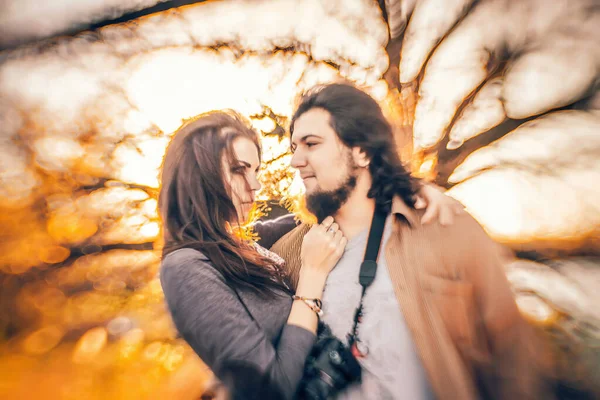 couple deeply in love against the backdrop of autumn. The strong and unconventional background blur, achieved with a specialized lens