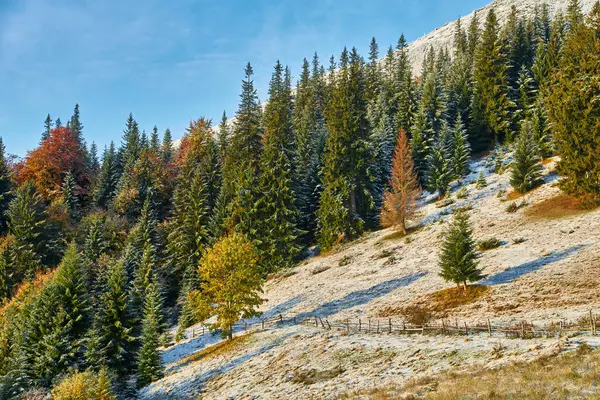 autumn landscape, the mountains come alive with the first snowfall.