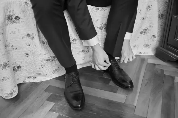 shiny black groom shoe with tuxedo trousers
