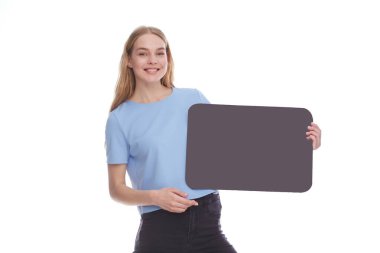 Vivacious young woman winking and laughing as she points at a blank signboard with copy space. isolated on white