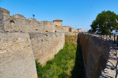 Akkerman Kalesi 'nin (Bilhorod-Dnistrovskyi Kalesi) iç avlusunun temiz mavi gökyüzünün altındaki taş kulelerini ve duvarlarını gösteren görüntüsü.