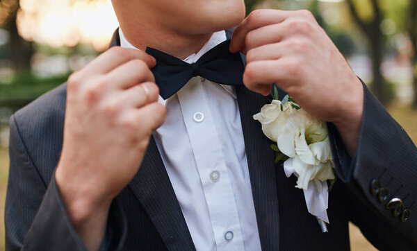 Metal water tower in the field against the blue sky and clouds