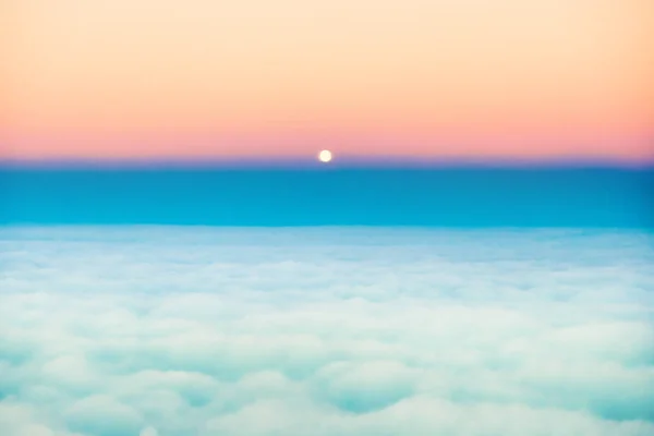 Sky and clouds sunset with full moon rising, aerial view from plane