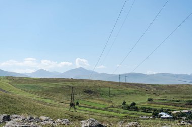 High voltage electricity tower landscape in Georgia clipart