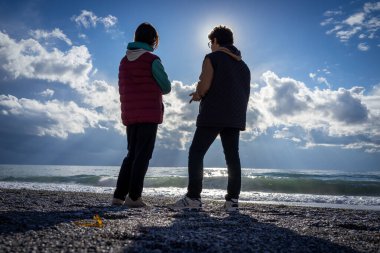 Çocuk kış kumsalında duruyor Gölge silueti yapıyor